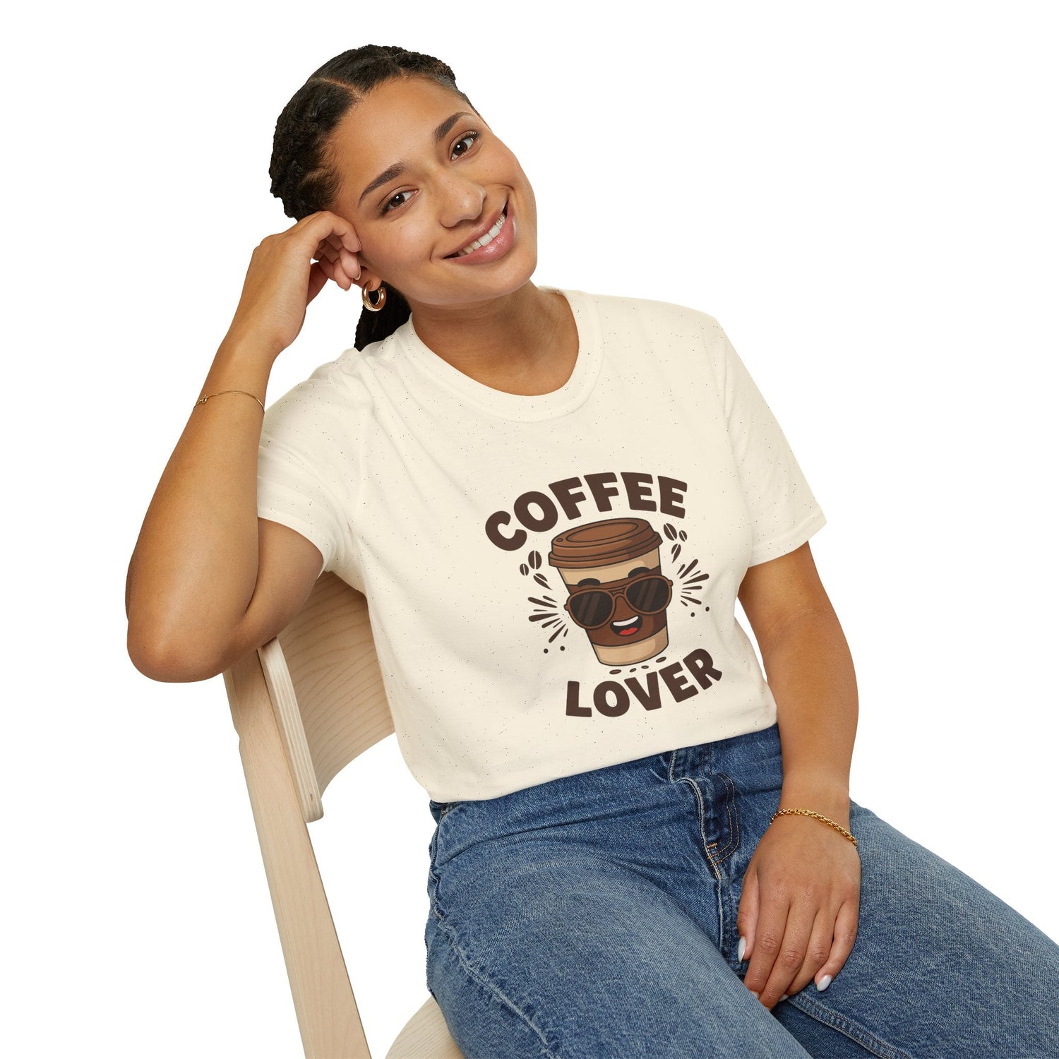 Smiling woman wearing a cream T-shirt with a cartoon coffee cup in sunglasses and the text ‘Coffee Lover’.